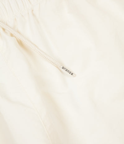 Bronze 56K 3M Track Pants - Off White | Flatspot