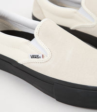 Black and white hotsell vans slip on pro